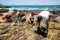 Volunteers remove black oil from the Rio Vermelho beach spilled by a ship in the Brazilian sea