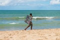 Beach vendor selling sunglasses at Itapua beach - popular beach in Salvador, Bahia