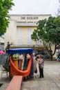 Older tourists looking at hammocks for sale, and the abandoned building of Cine Excelsior Royalty Free Stock Photo