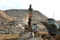 Salvaging and recycling building and construction materials. Excavator with hydraulic hammer work at landfill with concrete