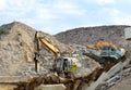 Salvaging and recycling building and construction materials. Excavator with hydraulic hammer work at landfill with concrete