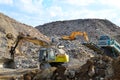Salvaging and recycling building and construction materials. Excavator with hydraulic hammer work at landfill with concrete