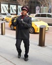 Salvation Army soldier performs for collections in midtown Manhattan during holidays season Royalty Free Stock Photo