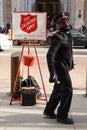 Salvation Army soldier performs for collections in midtown Manhattan during holidays season Royalty Free Stock Photo