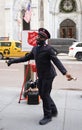 Salvation Army soldier performs for collections in midtown Manhattan during holidays season Royalty Free Stock Photo