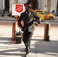 Salvation Army soldier performs for collections in midtown Manhattan during holidays season Royalty Free Stock Photo