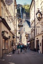 Salzburg, Austria - April 2015: Famous historical street Getreidegasse with multiple advertising signs. Royalty Free Stock Photo