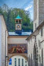 Mural and medieval painting and street clock located on Franziskanergasse, Salzburg, Austria