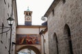 Salzburg, Austria, 28 August 2021: arch with religious fresco and small bell tower with clock at Franziskanergasse near