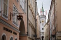 Salzburg, Austria, 28 August 2021: Grain Lane or Getreidegasse famous shopping narrow street in historic Altstadt, wrought iron