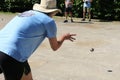 Portrait of a man throwing a boules ball. Austria.