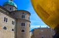 Salzburg, Austria - May 01, 2017: The golden ball statue with a man on the top sculpture, Kapitelplatz Square, Salzburg,