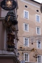 Famous historical street Getreidegasse with multiple advertising signs. Salzburg old town was listed as a UNESCO World Heritage Royalty Free Stock Photo