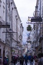 Famous historical street Getreidegasse with multiple advertising signs. Salzburg old town was listed as a UNESCO World Heritage Royalty Free Stock Photo