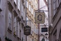 Famous historical street Getreidegasse with multiple advertising signs. Salzburg old town was listed as a UNESCO World Heritage Royalty Free Stock Photo