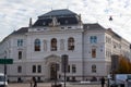 Kajetanerplatz square with fountain and building of Salzburg Regional Court