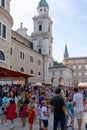 People enjoy the Salzburg town fair on a beautiful summer day