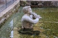 Stone sculpture of a Triton blowing on his conch shell trumpet. Salzburg, Austria.