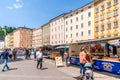 View of tourists enjoying the colorful GrÃÂ¼nmarkt at UniversitÃÂ¤tsplatz square, this bustling market