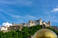 Salzburg Kapitelplatz with huge gold ball Goldkugel with a man and a church