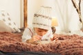 Samall cute blonde Boy writes letter to Santa Claus on the bed. Royalty Free Stock Photo