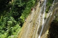 Samana, Dominican Republic, circa September 2022 - Locals running and jumping on Rio los Cocos Waterfall