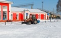 Samara, Chapaevsk, Russia-February.20.2018: Snow plow truck cleaning the forecourt of the street of Winter, the concept of snow Royalty Free Stock Photo