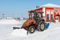 Samara, Chapaevsk, Russia-February.20.2018: Snow plow truck cleaning the forecourt of the street of Winter, the concept of snow Royalty Free Stock Photo