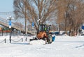 Samara, Chapaevsk, Russia-February.20.2018: Snow plow truck cleaning the forecourt of the street of Winter, the concept of snow Royalty Free Stock Photo