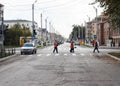 Samara, Chapaevsk, Russia - September, 2012. street cleaning workers are crossing the road
