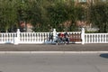 Samara, Chapaevsk, Russia, - September, 2019: two young men, teenagers on a bench, against a beautiful fence with balusters