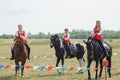 Girls in traditional Cossack costumes on horseback Royalty Free Stock Photo