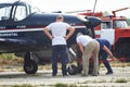 People look at the light sports aircraft standing on the airfield