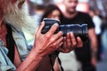 A photographer with a beard holding a camera