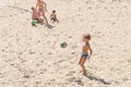 Boys teenagers playing soccer on the beach