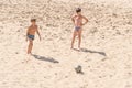 Boys teenagers playing soccer on the beach