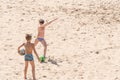 Boys teenagers playing soccer on the beach