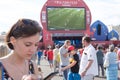 Girl with a phone in the fan zone of the FIFA world Cup 2018 in Samara