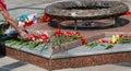 Samara, Russia, - may, 09, 2019: an elderly woman lays flowers at the monument to war veterans