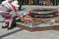 Samara, Russia, - may, 09, 2019: an elderly woman lays flowers at the monument to war veterans