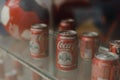 Samara Russia- 04.30.2019: metal cans of coca cola behind the window. Coca Cola Museum