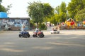 Little boys ride on childrens cars in the park