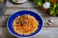 Samarkand pilaf lamb, rice, onion, yellow carrots, vegetable spices table in Uzbek national dish.