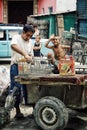 Father and kid recycling glass bottles from the trash dump close to the local market