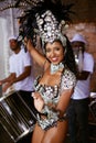 Samba the night away. a beautiful samba dancer posing in a carnival with her band.