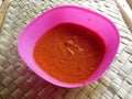 Sambal is a traditional Indonesian sauce. It is made from very hot chilli, tomatoes and spices Royalty Free Stock Photo