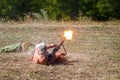 Mujahid shooting a machine gun lying down