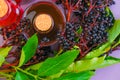 Sambucus syrup. Elderberry syrup.Sambucus berries. Elderberry harvest.Elderberry branches. syrup in a bottle and bunches Royalty Free Stock Photo