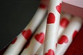One red heart straw with the same background. Royalty Free Stock Photo