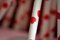 One red heart straw with the same background. Royalty Free Stock Photo